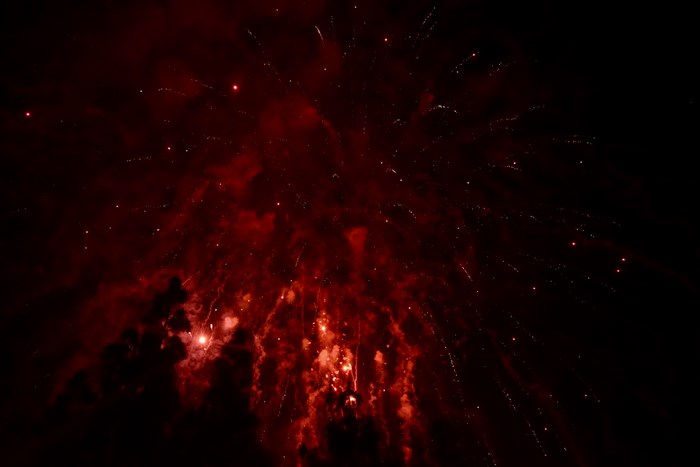 Red fireworks exploding in the night sky