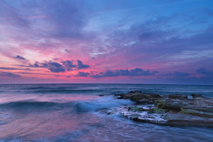 Serene Rocky Shoreline at Pink and Blue Sunrise