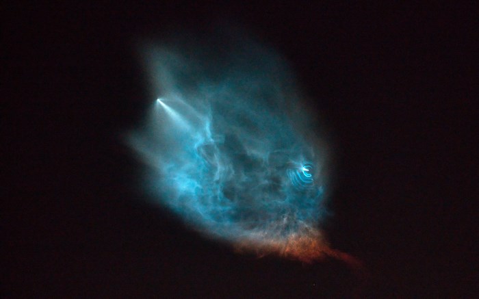 SpaceX rocket launch smoke trail in dark sky