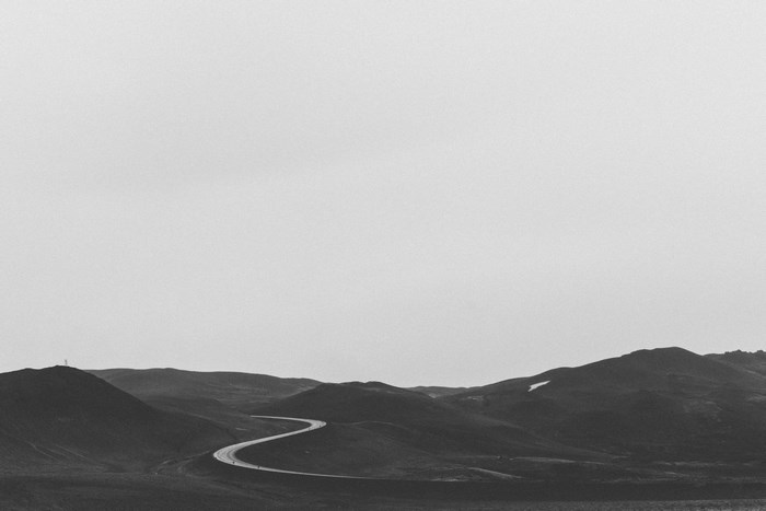Winding road through monochrome Icelandic highlands