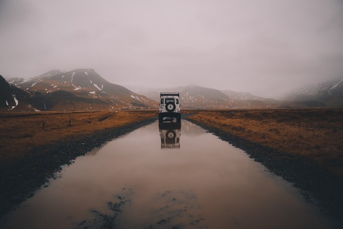 White Land Rover Defender on a flooded road in Iceland