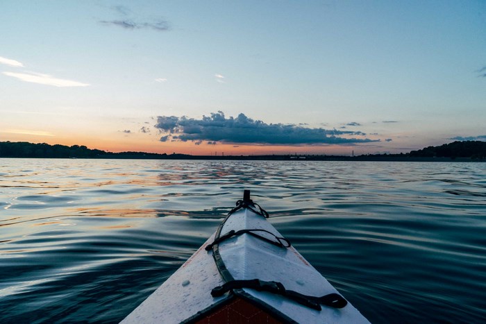 Kayak on water at sunset