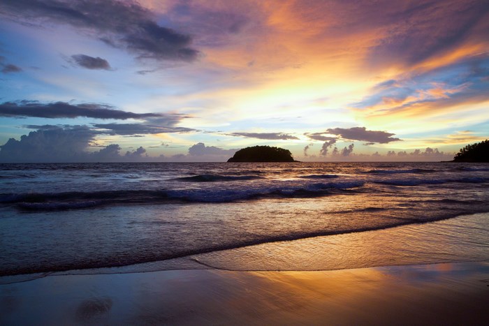 Sunset over the ocean with islands and beach