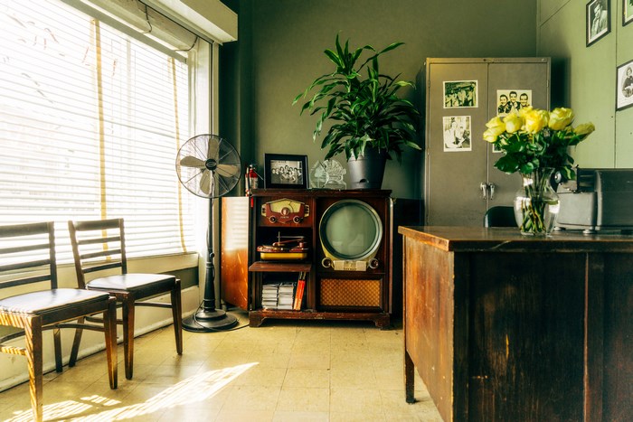 Vintage room with retro TV, fan, and chairs