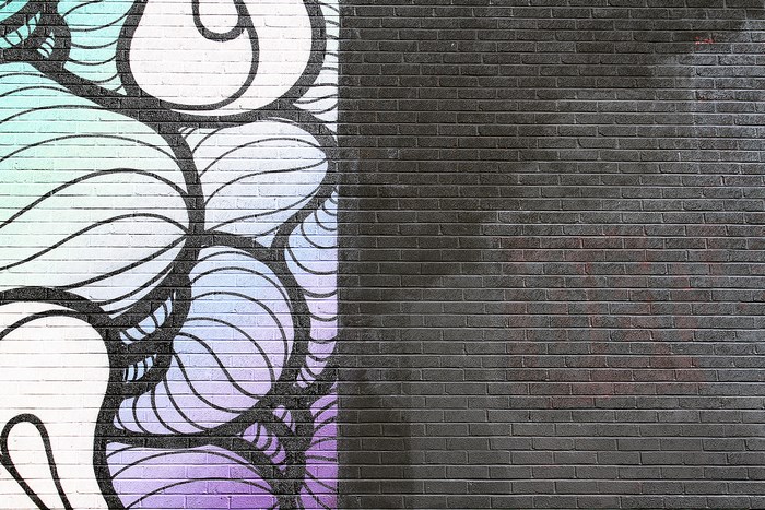 Graffiti art on a brick wall with gradient colors