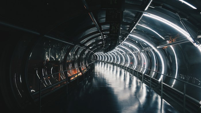 Futuristic tunnel with neon lights and reflections