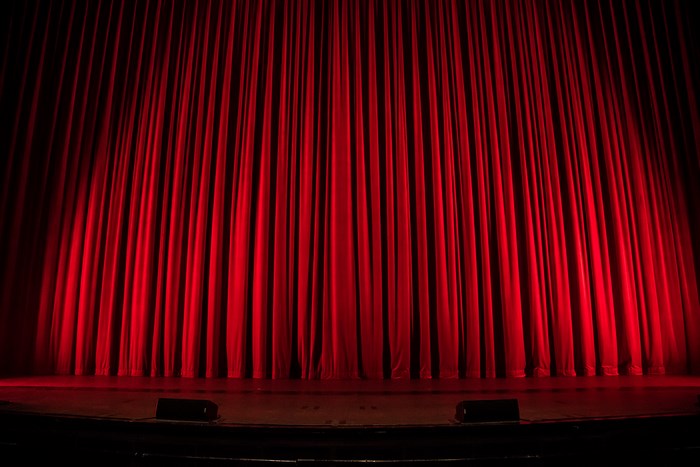 Red theater curtains on a stage