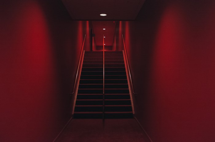 Red lit staircase in a dark interior