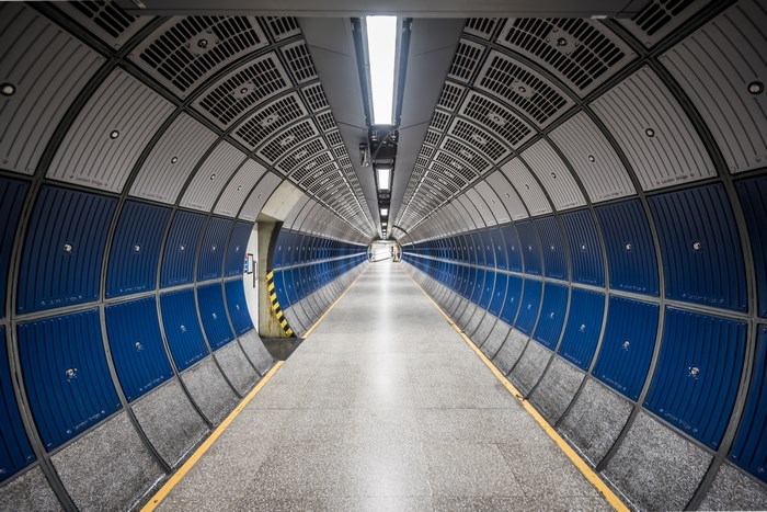 Empty geometric tunnel with blue and gray panels