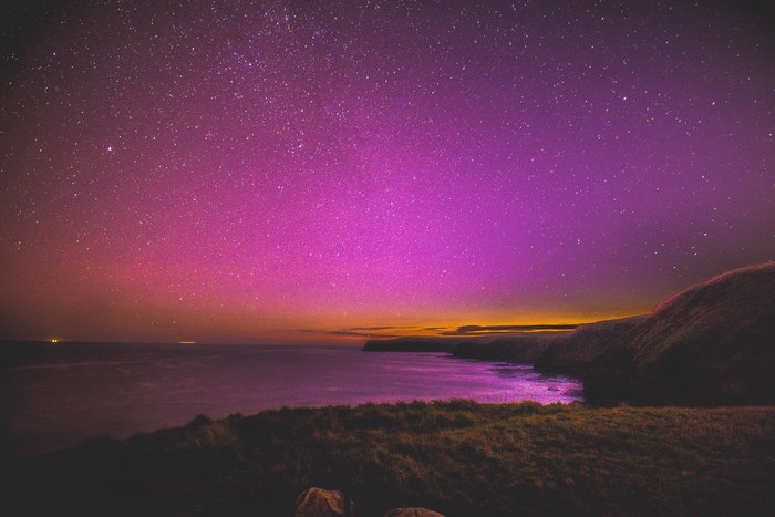 Night sky over the ocean coastline