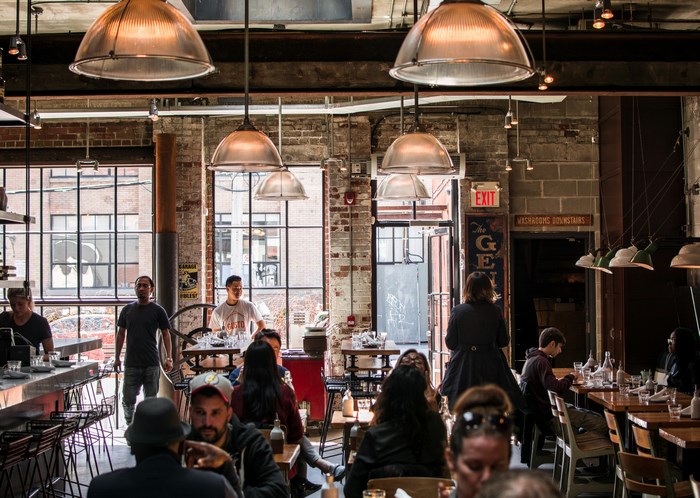 Restaurant interior with patrons and staff