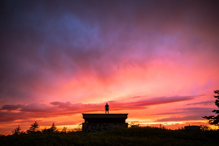 Man standing on bunker during sunset