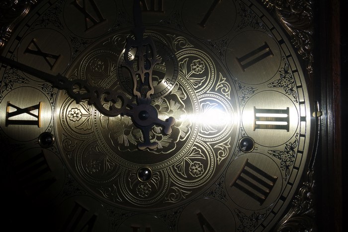 Close-up of an antique clock face with Roman numerals