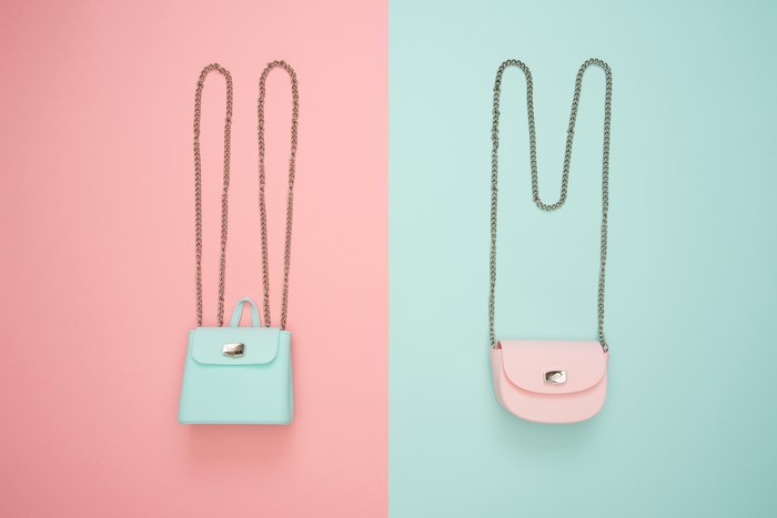 Two pastel bags with chain straps on a split background
