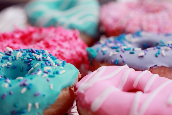 Assortment of colorful frosted donuts with sprinkles