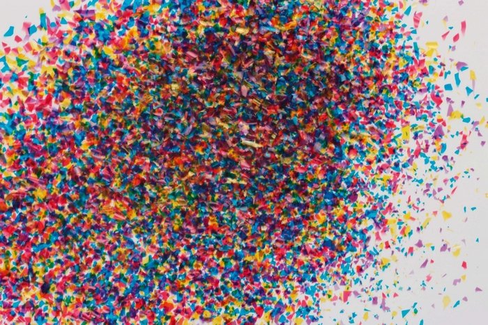 Scattered colorful confetti on a white background