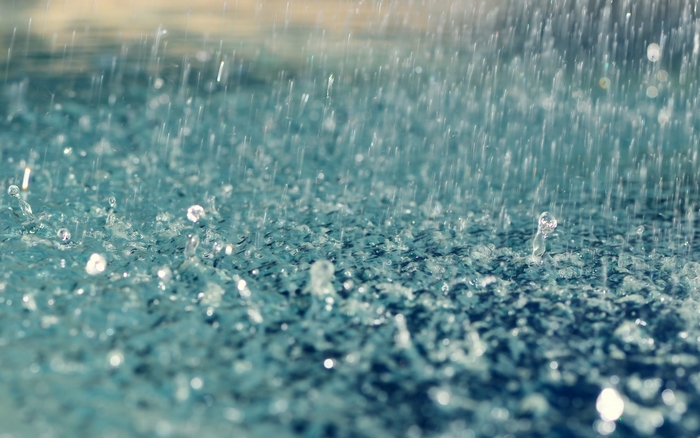 Raindrops falling on a textured surface