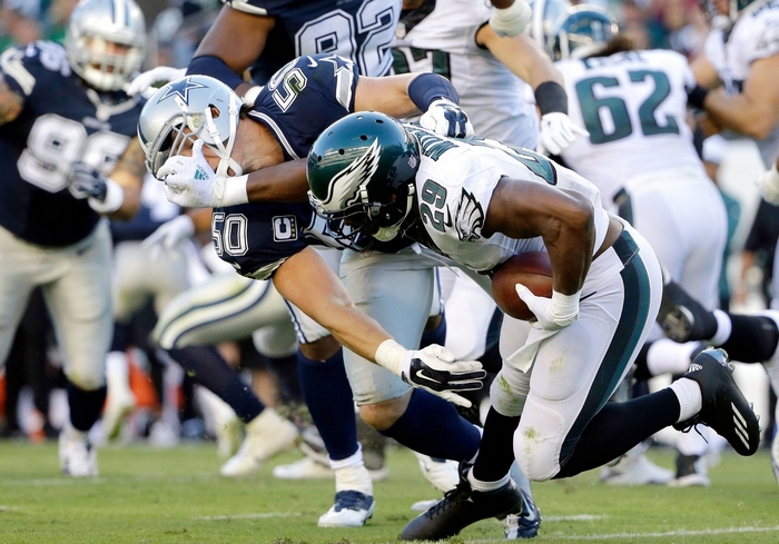 Philadelphia Eagles player tackled by Dallas Cowboys player