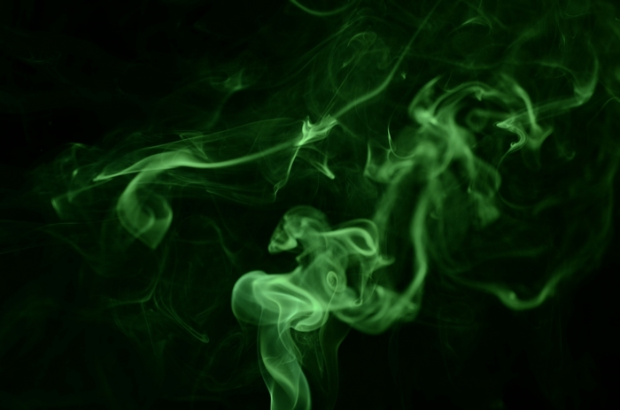 Green smoke swirling against black
