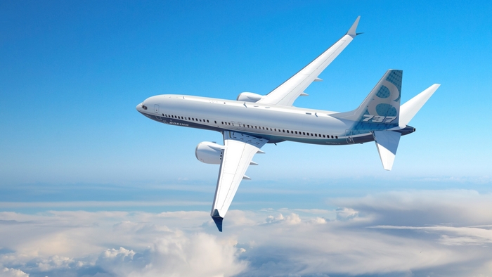 Boeing 737 airplane flying above clouds
