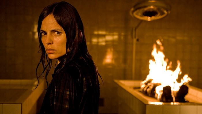 Woman in a dark room with fire