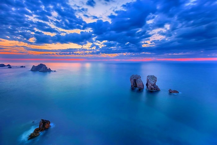 Ocean with rock formations at sunset