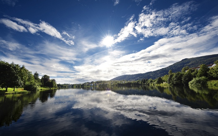 Lake with Mountains and Sunlit Sky