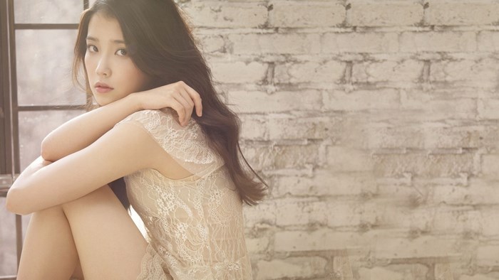 IU sitting by window