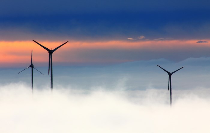 Wind turbines in the clouds at sunset