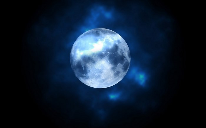 Full moon in dark sky with clouds