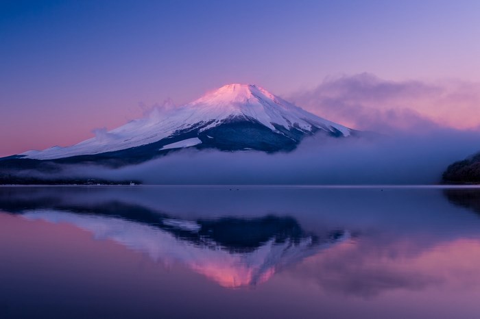 Mount Fuji reflected in a lake at sunrise