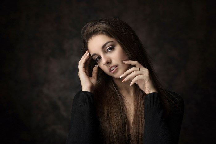 Amazing Portrait of Woman with Long Hair in Dark Sweater