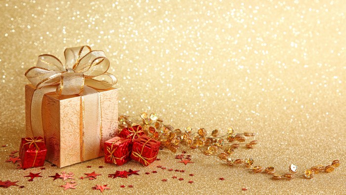 Gift boxes with ribbon and decorations on glitter background