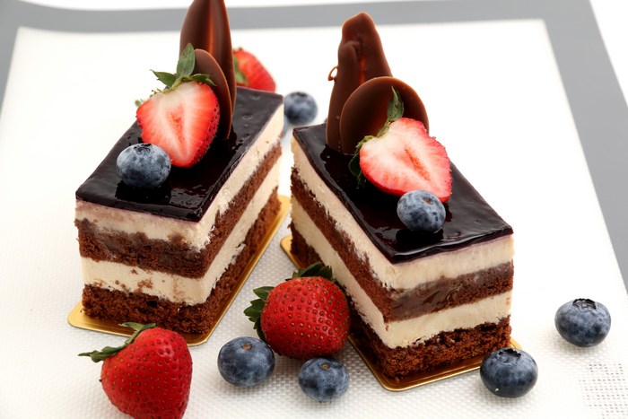 Chocolate layered cakes with strawberries and blueberries