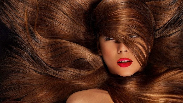 Woman with long brown hair and red lipstick