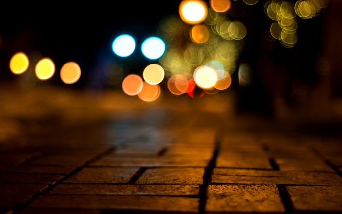 Bokeh lights on a brick path at night