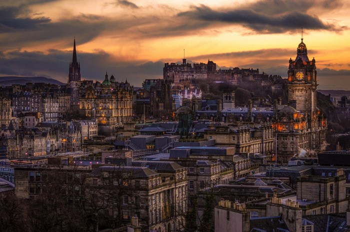Edinburgh cityscape with castle and clock tower at sunset
