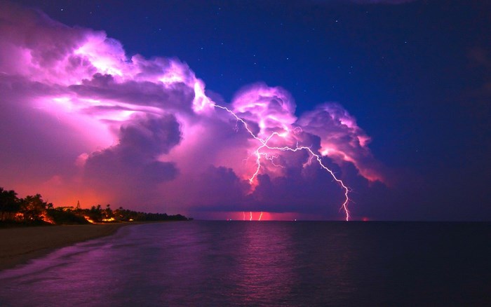 Lightning strikes over the ocean during a storm