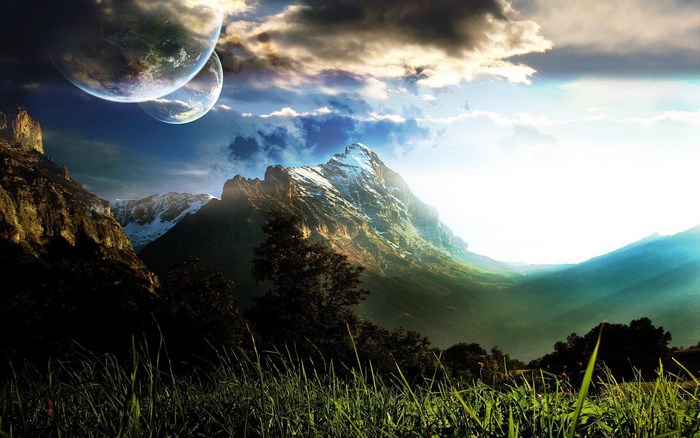 Two planets over snowy mountains and grassy field