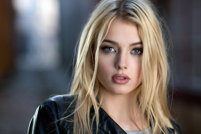 Blonde Woman with Intense Blue Eyes in Leather Jacket