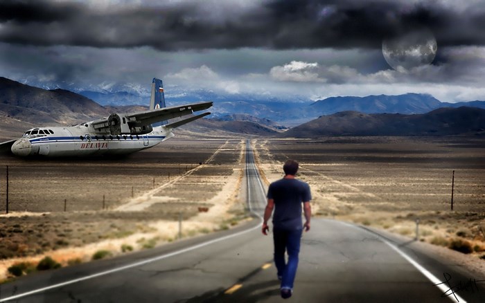 Man walks on road towards abandoned airplane