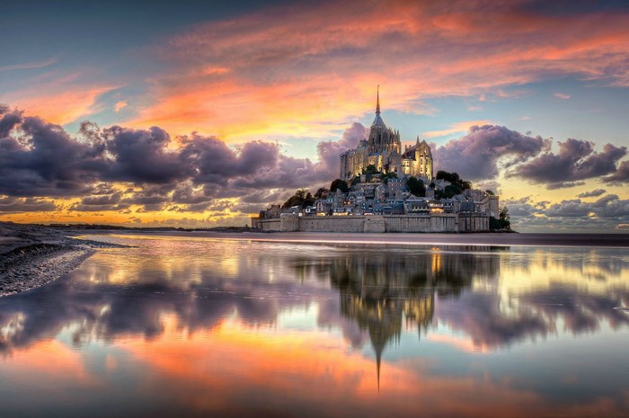 Mont Saint-Michel at sunset with reflection