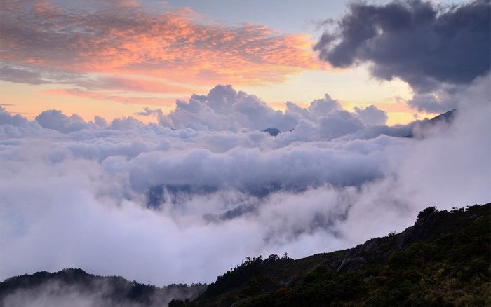 Sunset Above Clouds on Mountain Ridge