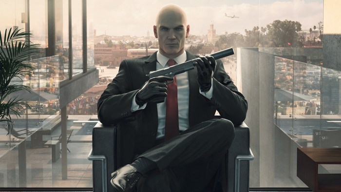 Agent 47 from Hitman holding a silenced pistol