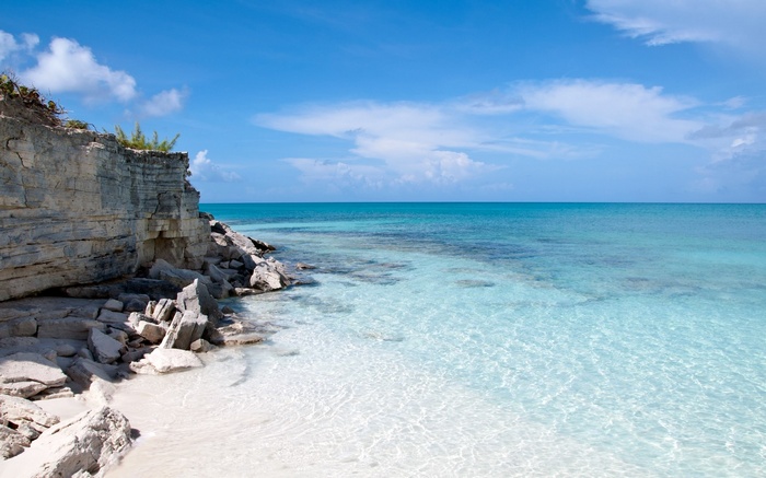Rocky coastline and clear turquoise ocean under a blue sky