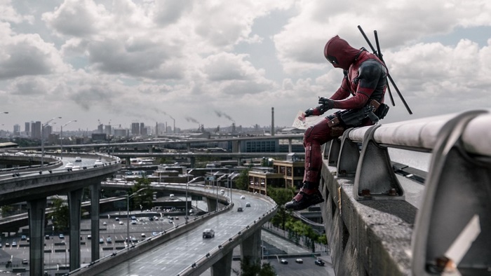 Deadpool sitting on a highway overpass