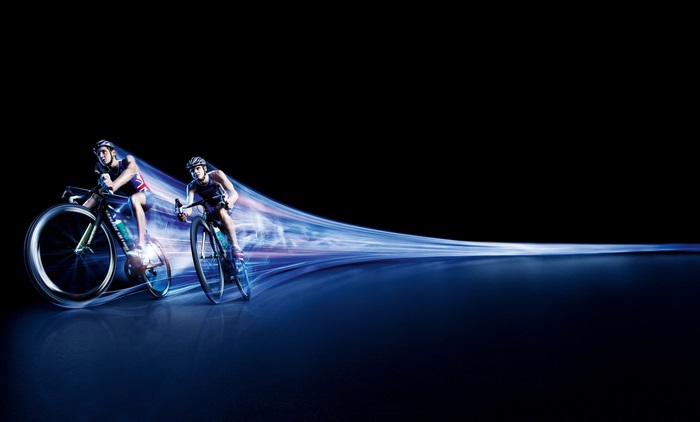 Two Cyclists Racing with Dynamic Light Trails