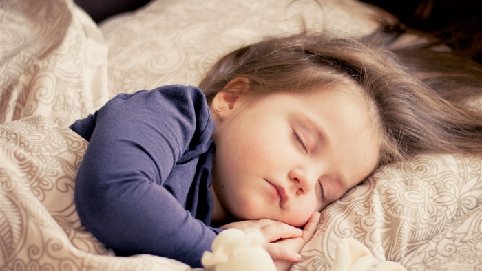 Child sleeping on bed