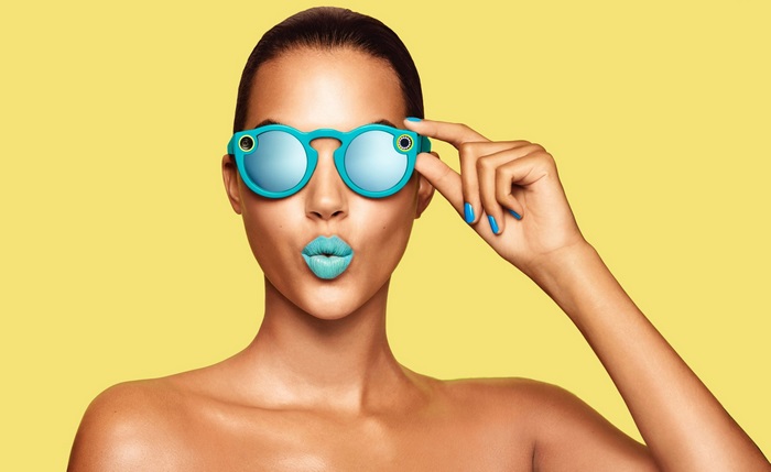 Woman wearing Snapchat glasses with blue lipstick