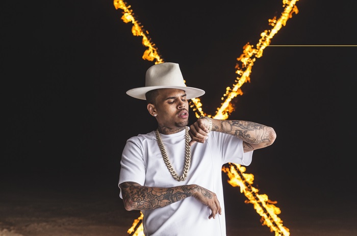 Chris Brown wearing a hat and chain